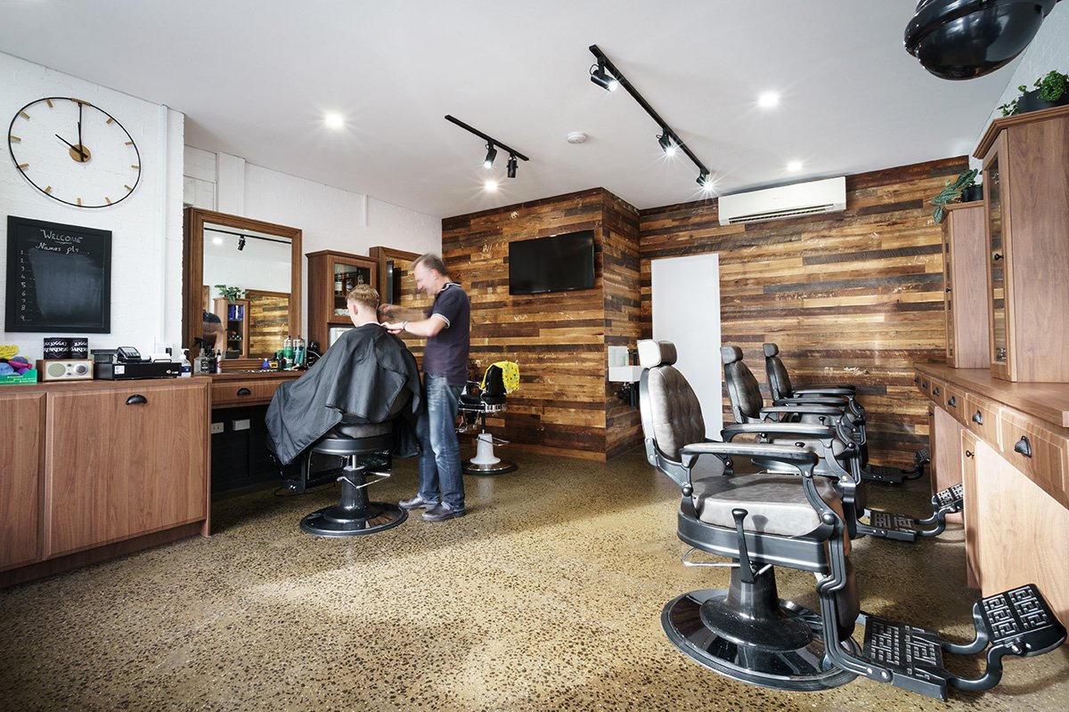 Interior of Jugga's Barbers, a local barbershop in Yarraville, showing vintage barber chairs and styling stations